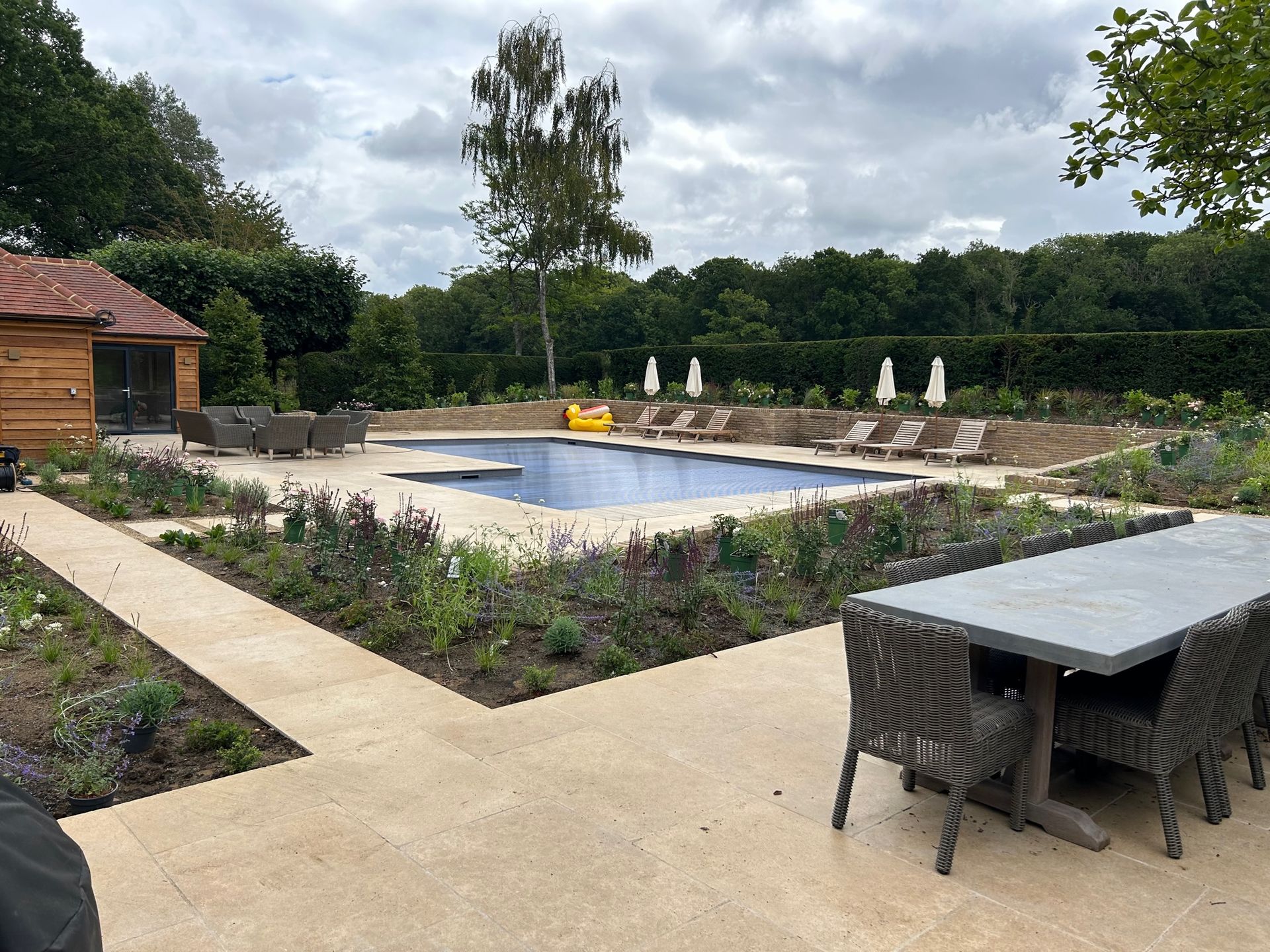 LED garden spotlights for Swimming Pool and flowerbeds set in a modern design with soft planting scheme