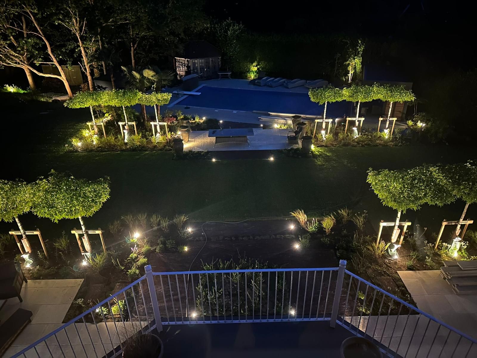 Outdoor Garden Lighting Design with up lights and down lights illuminating back garden features