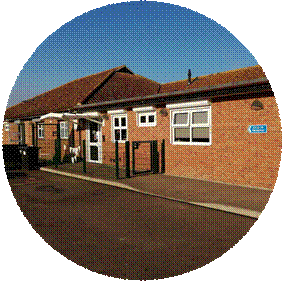 a brick building with fencing and a gate